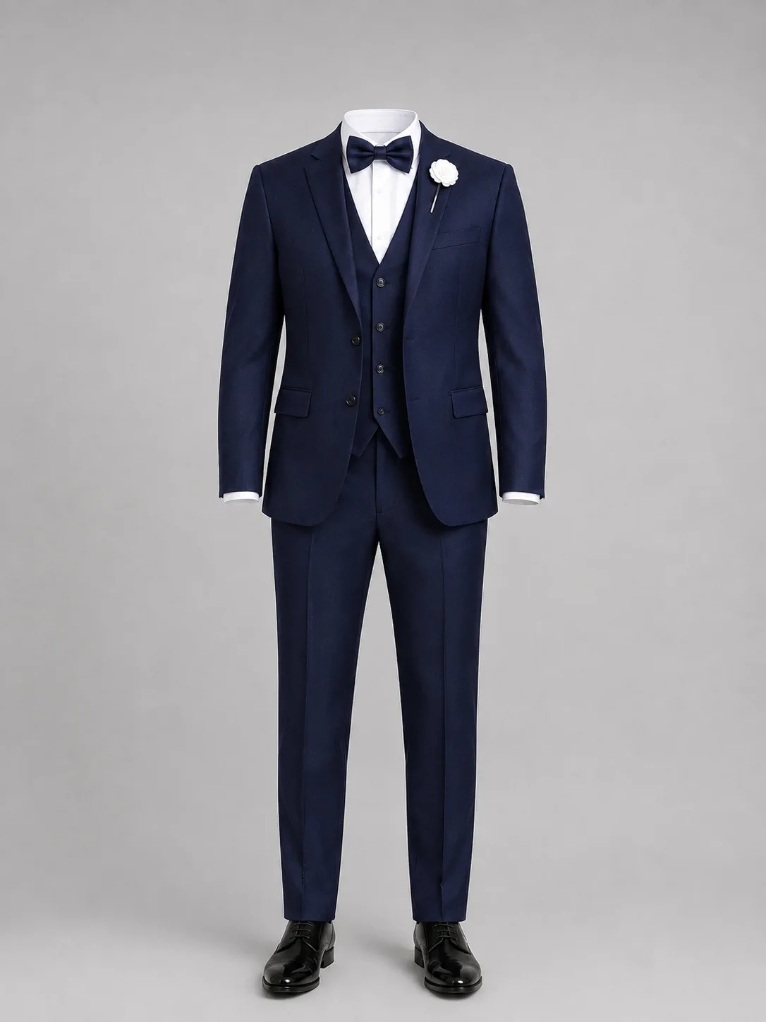 Navy three-piece suit with waistcoat, white shirt and bow tie